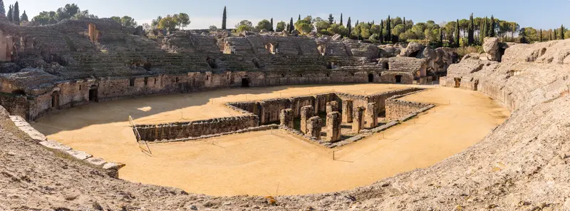The Roman amphitheatre of Itálica at Santiponce near Seville, with cypress trees on the rim