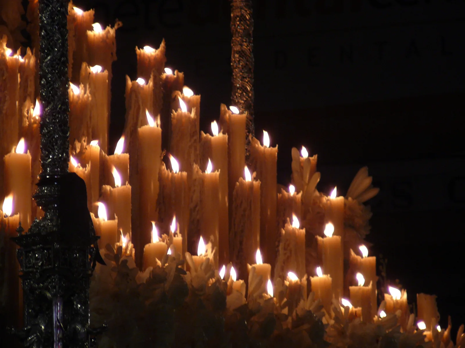 Candles burning on a Semana Santa paso during a Holy Week procession in Seville